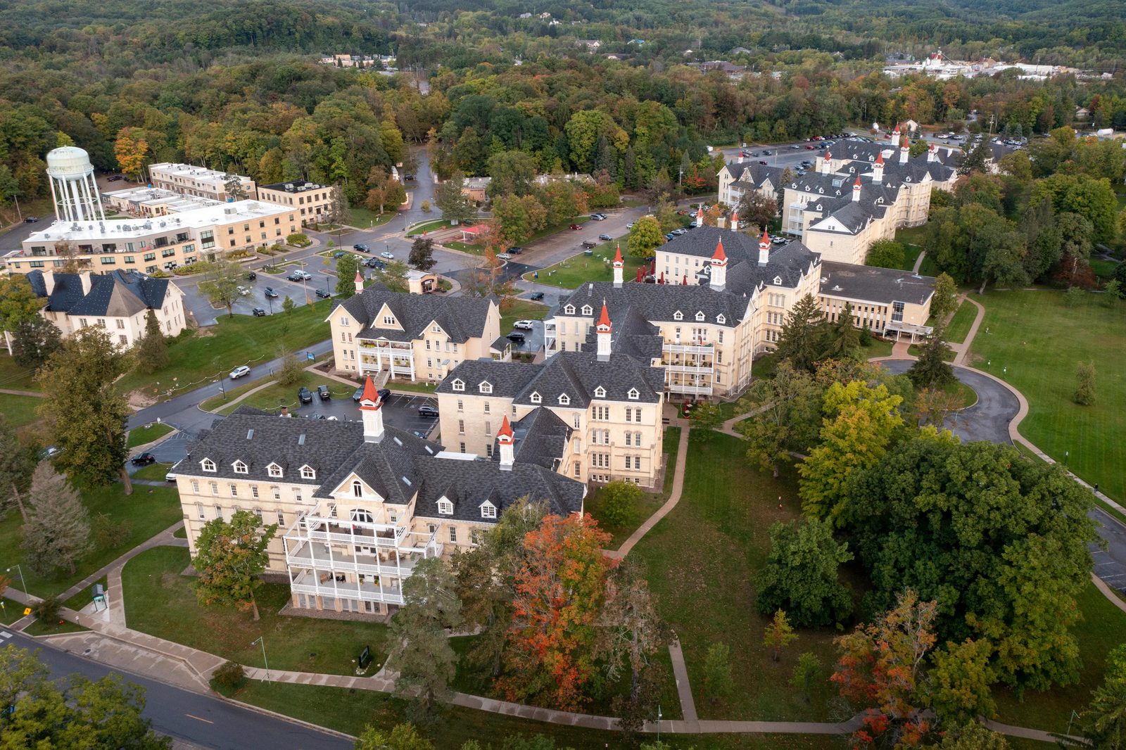 The Grand Traverse Commons: Building 50's yellow brick façade and spires rising above the lawn.